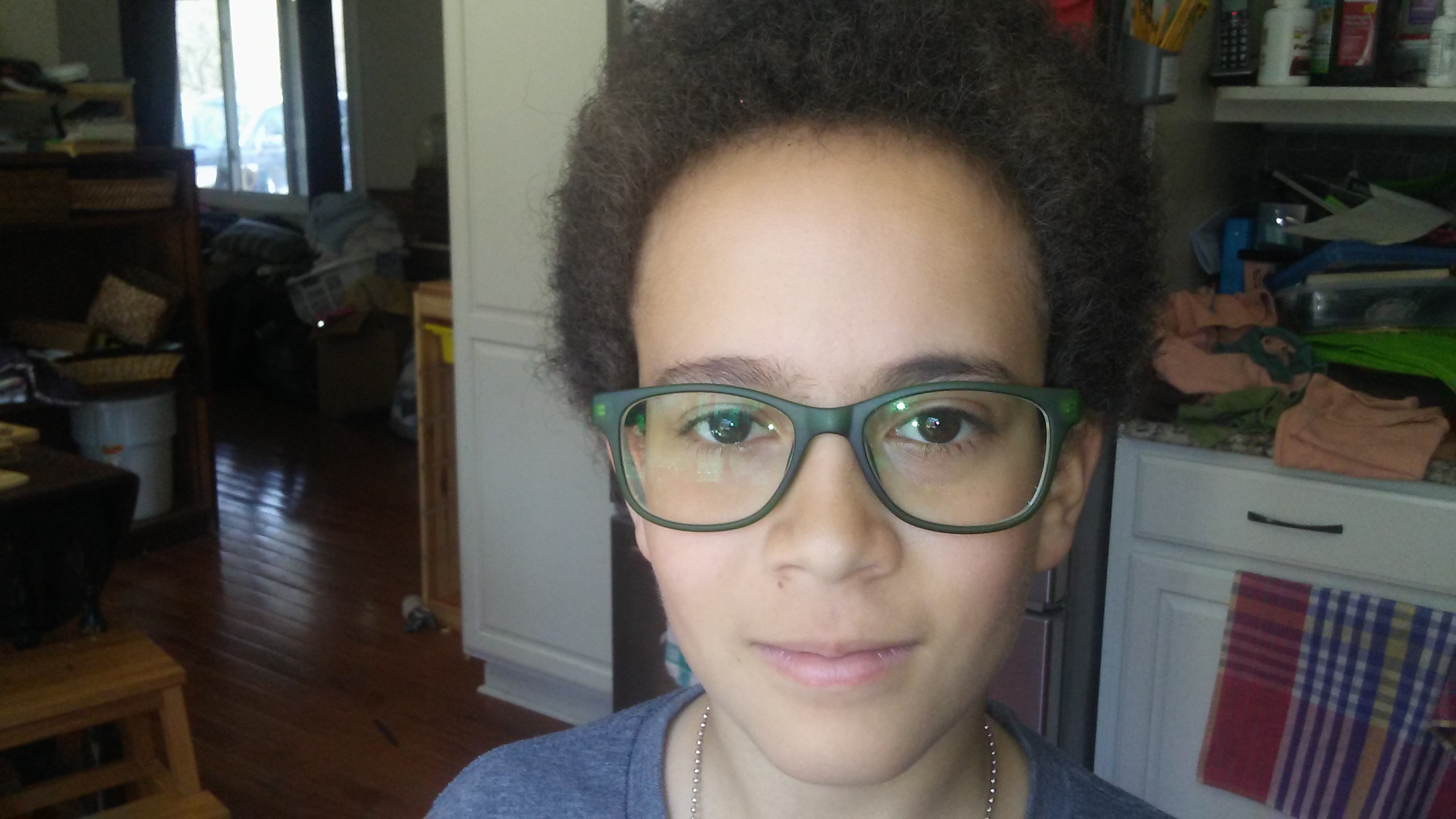 a boy wearing glasses with green plastic frames